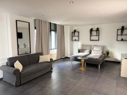 a living room with a couch and a table at Suite Julius Cesar mit Private Sauna & Whirlpool in Berlin