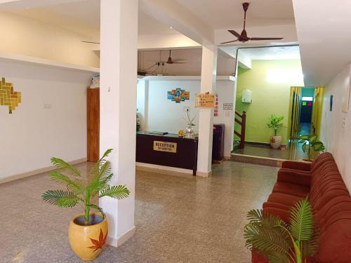 a living room with a couch and a lobby at De Dreams beach in Puducherry