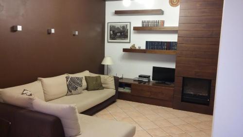 a living room with a couch and a fireplace at Casa Vacanze Prato Verde in Zafferana Etnea