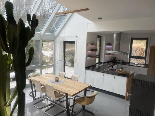 a kitchen with a table and chairs in a room at Ferienhaus am Dürrbachtal in Unterleinleiter