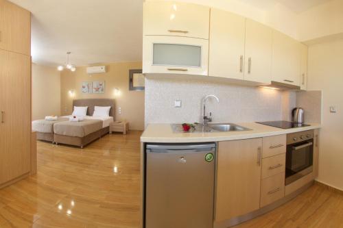 a kitchen with a sink and a couch in a room at Kefalonia Horizon Villas in Ayia Evfimia