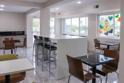 a bar in a restaurant with chairs and tables at Clarion Pointe Bettendorf - Quad Cities in Bettendorf