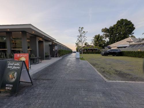 a cobblestone street in front of a building at Transit Samui Resort in Koh Samui