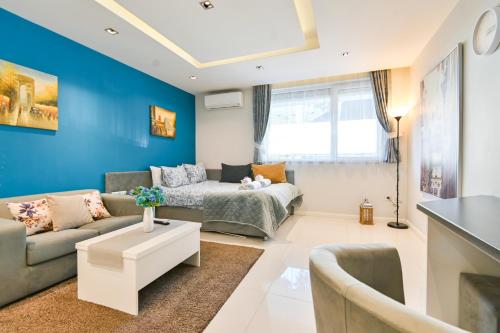 a living room with blue walls and a couch at N9 Studentski Loft in Sofia