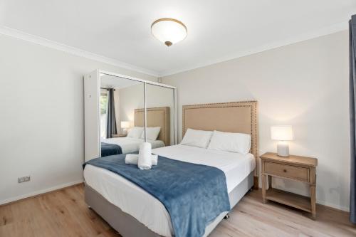a bedroom with two beds and a large mirror at Entire home in Southport Parade Southport in Gold Coast