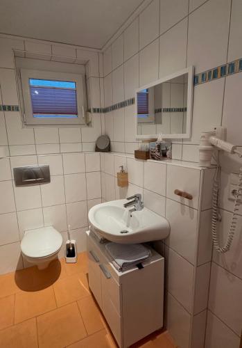 a bathroom with a sink and a toilet at Haus Alexandra in Rust