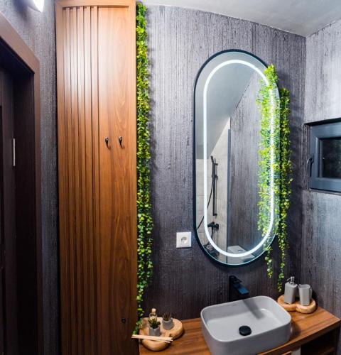 a bathroom with a sink and a mirror at Azimuth in Buhalniţa
