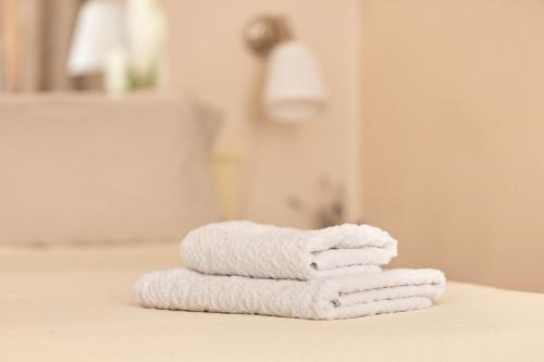 a stack of towels sitting on a counter in a bathroom at Gloria apartment Rovinj - Heart of Old town - Steps from Sea in Rovinj