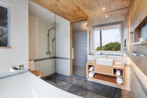 a bathroom with a sink and a shower at Fusion Suites Saigon in Ho Chi Minh City
