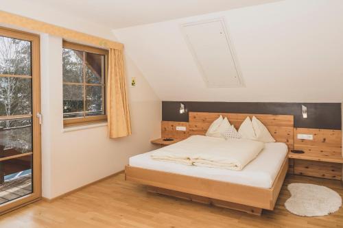 a bedroom with a bed and a window at Haus Sylvia in Mariapfarr