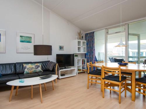 a living room with a couch and a table at 6 person holiday home in Ringkøbing in Ringkøbing