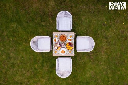 an overhead view of a table with food on it at StayVista at Moets Palm Villa with BBQ & Bonfire in Gurgaon