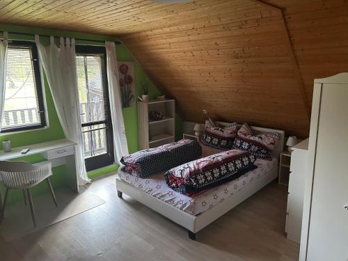 a bedroom with a bed with pillows on it at Chata Rožany in Šluknov