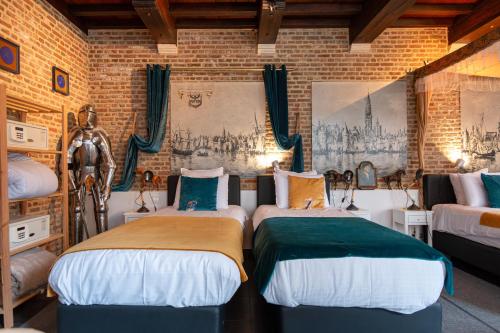a room with two beds in a brick wall at Charming Suites Jan Zonder Vrees in Antwerp