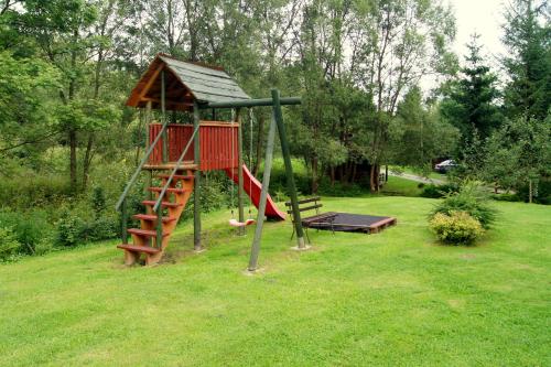 a playground with a ladder and a slide at U Eskulapa in Lutowiska