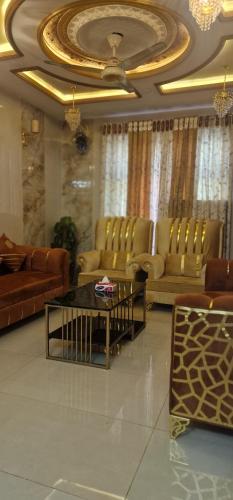 a living room with couches and a coffee table at Al IMRAN villa 2 bedroom apartment in Lahore