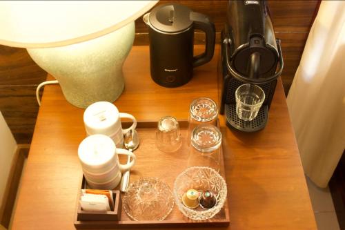 a table with a coffee maker and other items on it at Petit Paradis Hiriketiya in Hiriketiya