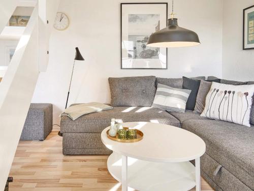 a living room with a couch and a table at 5 person holiday home on a holiday park in Gudhjem in Gudhjem
