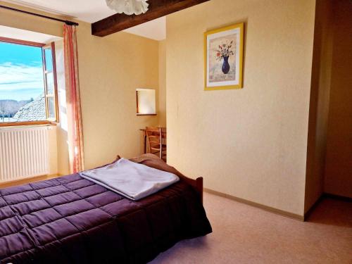 a bedroom with a purple bed and a window at Gîte de Saint-Gervais in Saint-Gervais