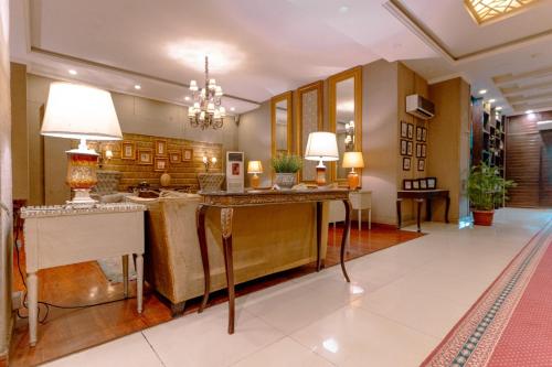 a lobby of a hotel with a table and lamps at Shelton's Rezidor Peshawar in Peshawar