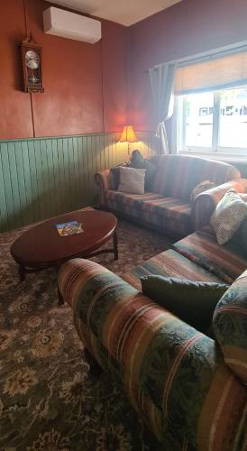 a living room with a couch and a table at May Queen Forest Cottage Manjimup in Deeside