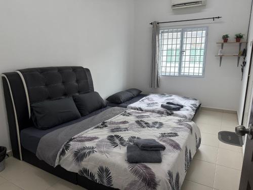 a bedroom with a bed and a couch at Serenity Haven Family Stay Ipoh 10-12 Pax in Ipoh