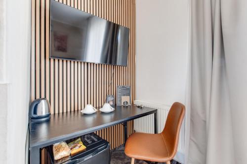 a hotel room with a desk and a chair at Hotel Andante in Prague
