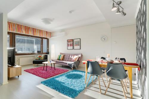 a living room with a couch and a table at Aurora Atelier in Rovaniemi