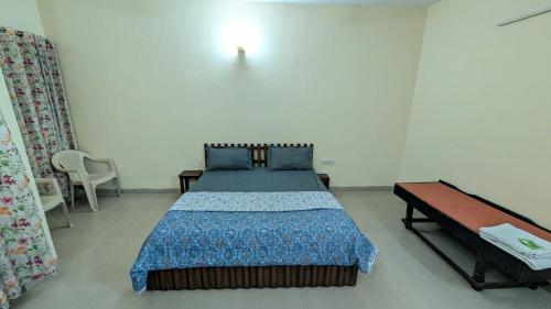 a bedroom with a large bed and a table at Meera 1 bhk Palace Omaxe in Vrindāvan