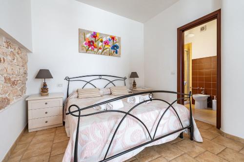a bedroom with a bed and a bathroom at Helios Vacanze in Conversano