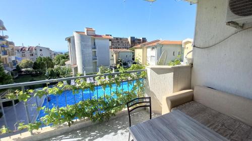 a balcony with a view of a swimming pool at Family 2BDR Apartment in the City Center in Sveti Vlas