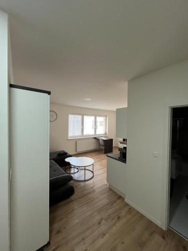 a living room with a couch and a table at Central and Spacious Apartment with All Amenities in Nitra