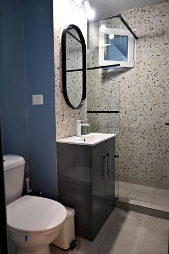 a bathroom with a toilet and a sink and a mirror at Eve's Central in Brăila