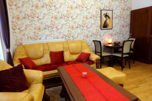 a living room with a couch and a table at Tatra Apartment Palace Hill with angels and sauna in Poprad