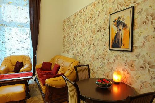 a living room with a couch and a table at Tatra Apartment Palace Hill with angels and sauna in Poprad