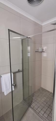 a shower with a glass door in a bathroom at Mila's at Panorama in Panorama
