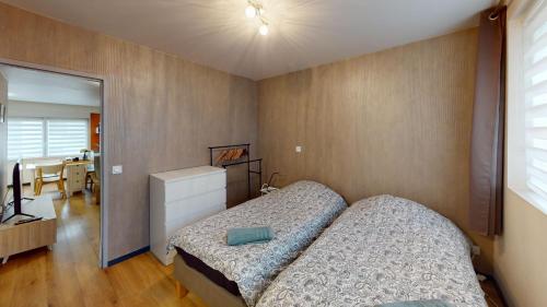 a bedroom with a bed and a desk with a television at T2 Cozy & Elegant, 5 min walk to Nausicaá in Boulogne-sur-Mer