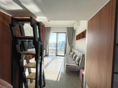 a living room with a couch and a staircase to a room at City & River Views near Royal Palace and Watphnom in Phnom Penh