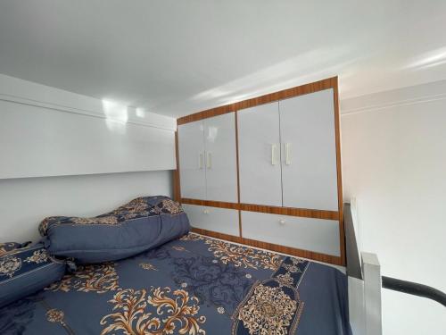 a small bedroom with a bed and a closet at City & River Views near Royal Palace and Watphnom in Phnom Penh