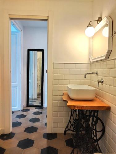 a bathroom with a white sink and a mirror at Casa Salvàn in Rodello