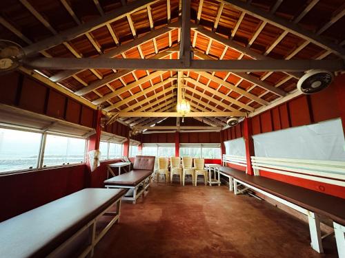 a dining room with tables and chairs in a building at SeaCret by Dormer Stay in Kozhikode
