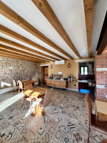 a dining room with a table and chairs and a brick wall at Agriturismo Tamellini in Soave