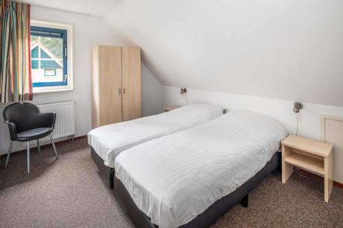 Ένα ή περισσότερα κρεβάτια σε δωμάτιο στο Zandduin Villa | 12 personen