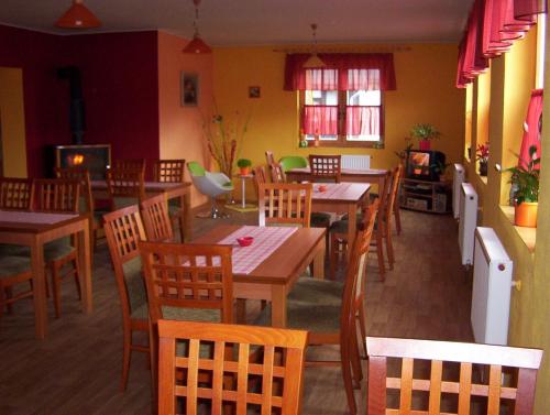 a dining room with wooden tables and chairs at Penzión Šindléry 533 in Partizánska ľupča