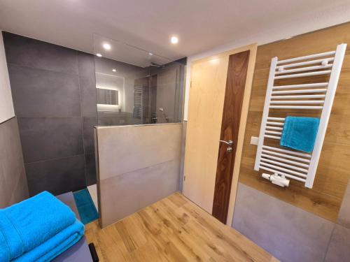a bathroom with a shower with blue towels at Haus Tauernblick in Berchtesgaden