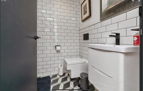 a white bathroom with a sink and a toilet at Duplex Apartment Harbourside city centre in Bristol