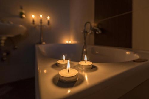 three candles sitting on top of a bathroom sink at Villa Marella in Trogir