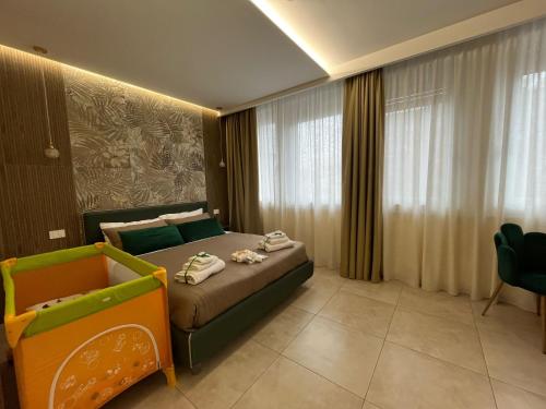 a hotel room with a bed and a chair at Casa Giardina in Catania