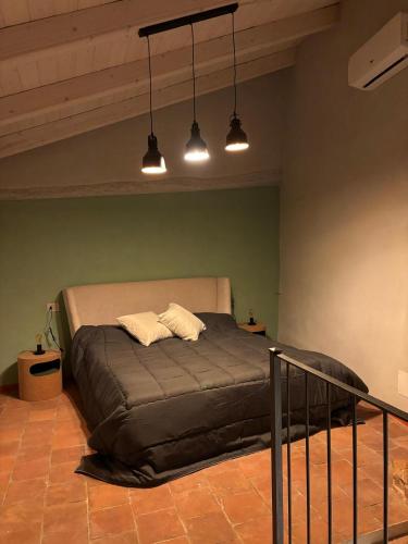 a bedroom with a bed with two pillows on it at FilAuri La Morra in La Morra