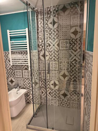 a bathroom with a shower with a toilet and a sink at FilAuri La Morra in La Morra